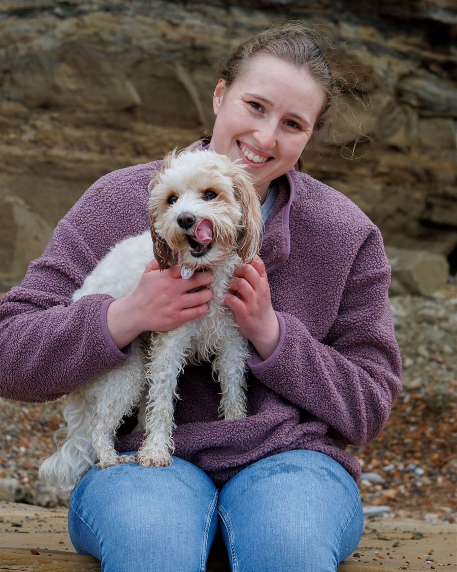 Emily holding Nala on the beach