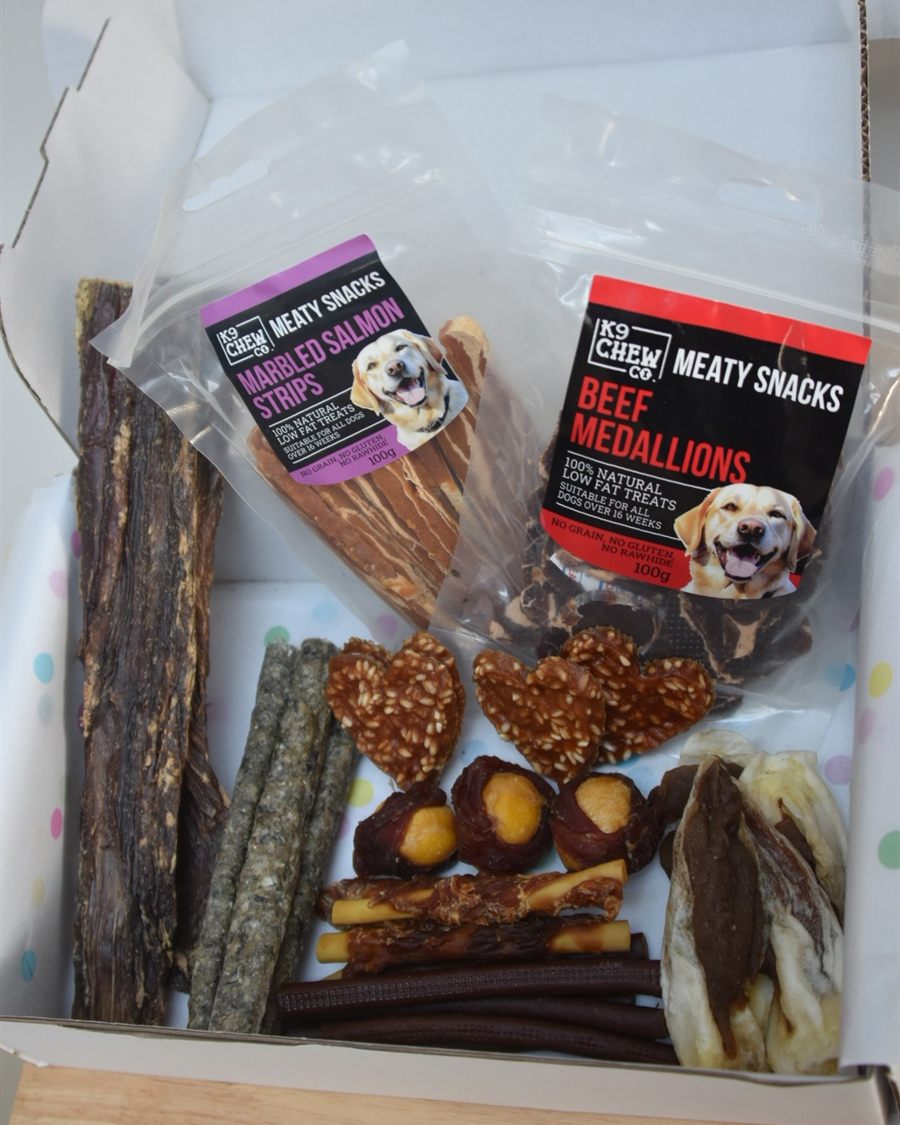 Nala's open treat box from above, with marbled salmon strips and beef medallions